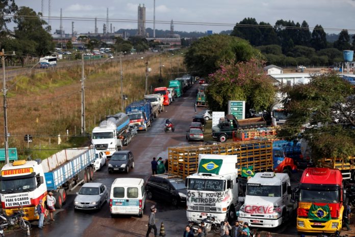 Trucks block the main entrance to President Getulio Vargas oil refinery in Araucaria